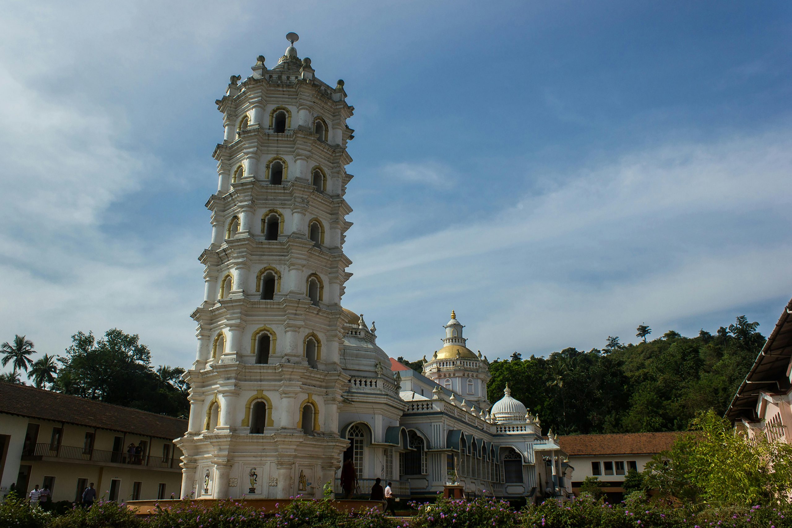 Trips A magnificent view of the Mangueshi Temple tower with a clear blue sky backdrop.