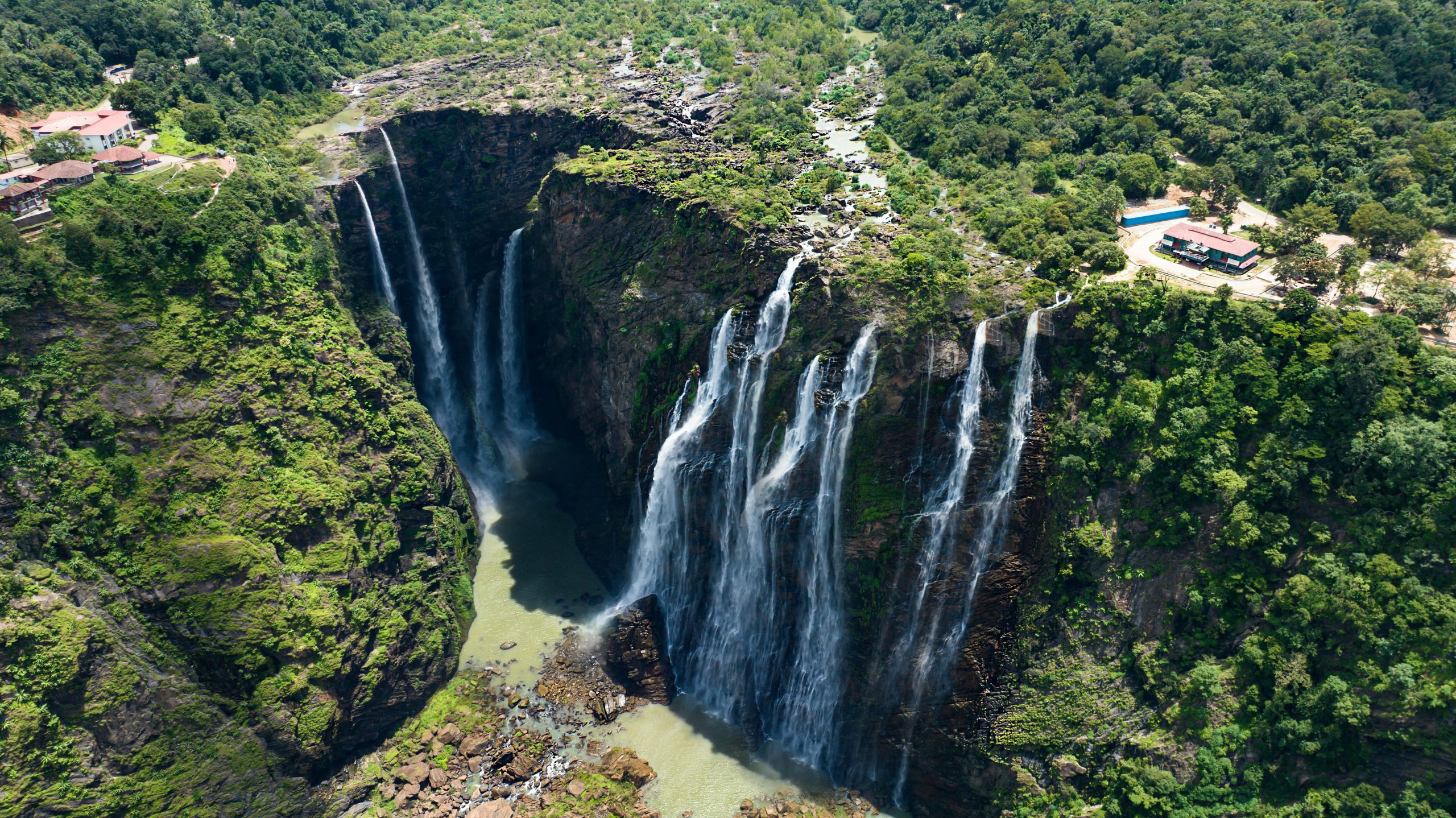 Trips A breathtaking aerial shot capturing lush greenery and cascading waterfalls.